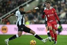 Newcastle United's Brazilian midfielder #07 Joelinton (L) clashes with Liverpool's Argentinian midfielder #10 Alexis Mac Allister during the English Premier League football match between Newcastle United and Liverpool at St James' Park in Newcastle-upon-Tyne, north east England on December 4, 2024. (Photo by Paul ELLIS / AFP) 