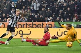 Anthony Gordon scores against Liverpool earlier this season.