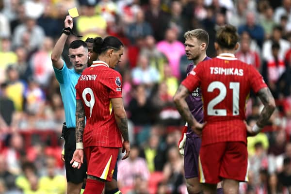 Referee Lewis Smith shows a yellow card to Liverpool's Uruguayan striker #09 Darwin Nunez during the English Premier League football match between Liverpool and Southampton at Anfield in Liverpool, north west England on March 8, 2025. (Photo by Paul ELLIS / AFP)
