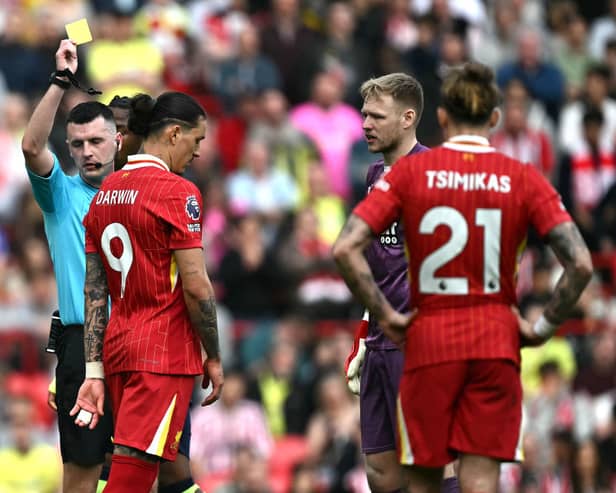 Referee Lewis Smith shows a yellow card to Liverpool's Uruguayan striker #09 Darwin Nunez during the English Premier League football match between Liverpool and Southampton at Anfield in Liverpool, north west England on March 8, 2025. (Photo by Paul ELLIS / AFP)