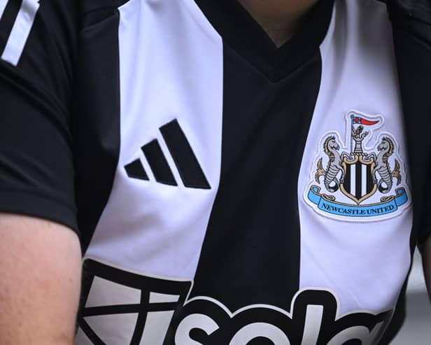  The Adidas logo and club badge are seen on the shirt of the new home kit during the Premier League match between Newcastle United FC and Southampton FC at St James' Park on August 17, 2024 in Newcastle upon Tyne, England. (Photo by Stu Forster/Getty Images)
