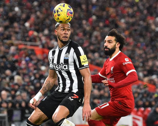 Newcastle United's Brazilian striker #07 Joelinton (L) vies with Liverpool's Egyptian striker #11 Mohamed Salah (R) during the English Premier League football match between Liverpool and Newcastle United at Anfield in Liverpool, north west England on January 1, 2024. (Photo by PETER POWELL / AFP) / 