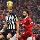 Newcastle United's Brazilian striker #07 Joelinton (L) vies with Liverpool's Egyptian striker #11 Mohamed Salah (R) during the English Premier League football match between Liverpool and Newcastle United at Anfield in Liverpool, north west England on January 1, 2024. (Photo by PETER POWELL / AFP) / 