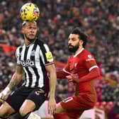 Newcastle United's Brazilian striker #07 Joelinton (L) vies with Liverpool's Egyptian striker #11 Mohamed Salah (R) during the English Premier League football match between Liverpool and Newcastle United at Anfield in Liverpool, north west England on January 1, 2024. (Photo by PETER POWELL / AFP) / 