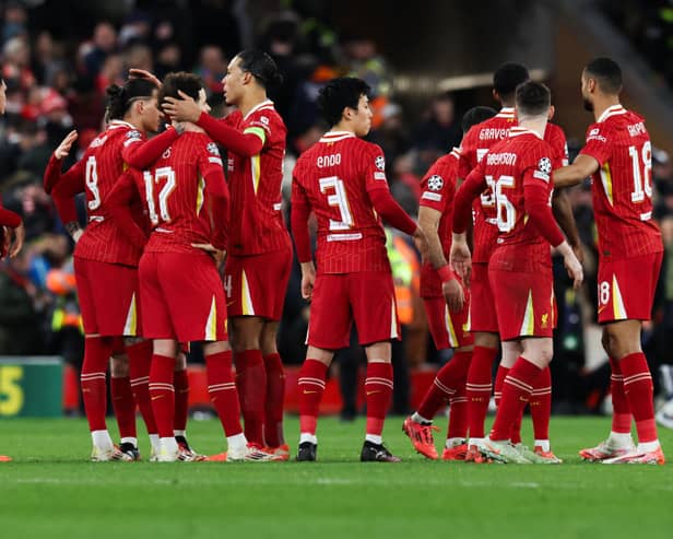 Liverpool's Dutch defender #04 Virgil van Dijk (C) comforts Liverpool's Uruguayan striker #09 Darwin Nunez and Liverpool's English midfielder #17 Curtis Jones at the end of the last 16 second leg UEFA Champions League football match between Liverpool and Paris Saint-Germain. . (Photo by Darren Staples / AFP) (Photo by DARREN STAPLES/AFP via Getty Images)          