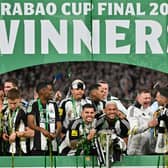 Newcastle United's Brazilian midfielder #39 Bruno Guimaraes (C-L) and Newcastle United's Brazilian midfielder #07 Joelinton (C-R) celebrate with the League Cup trophy after winning the English League Cup final football match between Liverpool and Newcastle United at Wembley Stadium, north-west London on March 16, 2025. Newcastle United wins English League Cup 2 -1 against Liverpool. (Photo by Glyn KIRK).