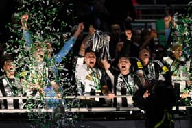 Bruno Guimaraes and Kieran Trippier of Newcastle United lift the Carabao Cup Trophy after their team's victory in the Carabao Cup Final between Liverpool and Newcastle United at Wembley Stadium on March 16, 2025 in London, England. (Photo by Stu Forster/Getty Images)