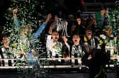 Bruno Guimaraes and Kieran Trippier of Newcastle United lift the Carabao Cup Trophy after their team's victory in the Carabao Cup Final between Liverpool and Newcastle United at Wembley Stadium on March 16, 2025 in London, England. (Photo by Stu Forster/Getty Images)