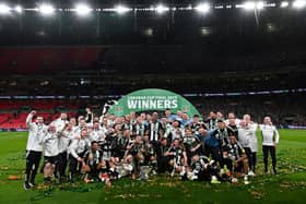 Newcastle United's players celebrate with the League Cup trophy after winning the English League Cup final football match between Liverpool and Newcastle United at Wembley Stadium, north-west London on March 16, 2025. Newcastle United wins English League Cup 2 -1 against Liverpool. (Photo by Glyn KIRK / AFP) 