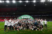 Newcastle United's players celebrate with the League Cup trophy after winning the English League Cup final football match between Liverpool and Newcastle United at Wembley Stadium, north-west London on March 16, 2025. Newcastle United wins English League Cup 2 -1 against Liverpool. (Photo by Glyn KIRK / AFP) 