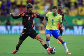 Bruno Guimaraes of Brazil and Richard Rios of Colombia battle for the ball during the South American FIFA World Cup 2026 Qualifier match between Brazil and Colombia at Mane Garrincha Stadium on March 20, 2025 in Brasilia, Brazil. (Photo by Buda Mendes/Getty Images)