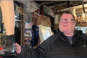 Shop owner holding an artificial leg