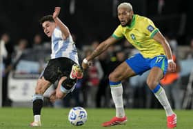 Argentina's forward #09 Julian Alvarez and Brazil's midfielder #17 Joelinton fight for the ball during the 2026 FIFA World Cup South American qualifiers football match between Argentina and Brazil at the Mas Monumental stadium in Buenos Aires province, on March 25, 2025. (Photo by JUAN MABROMATA / AFP) 