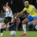 Argentina's forward #09 Julian Alvarez and Brazil's midfielder #17 Joelinton fight for the ball during the 2026 FIFA World Cup South American qualifiers football match between Argentina and Brazil at the Mas Monumental stadium in Buenos Aires province, on March 25, 2025. (Photo by JUAN MABROMATA / AFP) 