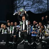 Newcastle United's English defender #33 Dan Burn celebrates with the League Cup trophy on stage at the Town Moor in Newcastle upon Tyne, in north-east England, on March 29, 2025, during a celebration and presentation with fans after Newcastle United won the English League Cup, their first domestic trophy for 70 years. (Photo by Oli SCARFF / AFP) (Photo by OLI SCARFF/AFP via Getty Images)          