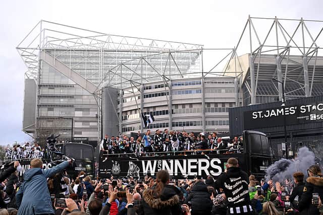 Joelinton, Kieran Trippier, Bruno Guimaraes, Harvey Barnes, Mark Gillespie, Dan Burn, celebrate with the Carabao Cup Trophy as Eddie Howe, Manager of Newcastle United, Anthony Gordon look on during the Newcastle United trophy parade and celebration. (Photo by Stu Forster/Getty Images)