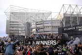 Joelinton, Kieran Trippier, Bruno Guimaraes, Harvey Barnes, Mark Gillespie, Dan Burn, celebrate with the Carabao Cup Trophy as Eddie Howe, Manager of Newcastle United, Anthony Gordon look on during the Newcastle United trophy parade and celebration. (Photo by Stu Forster/Getty Images)