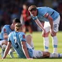 Kevin De Bruyne and Phil Foden (obscured) of Manchester City interact team mate Erling Haaland after he sustains an injury during the Emirates FA Cup Quarter Final match between AFC Bournemouth and Manchester City at Vitality Stadium on March 30, 2025 in Bournemouth, England. 