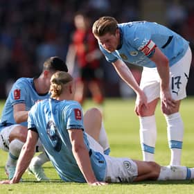 Kevin De Bruyne and Phil Foden (obscured) of Manchester City interact team mate Erling Haaland after he sustains an injury during the Emirates FA Cup Quarter Final match between AFC Bournemouth and Manchester City at Vitality Stadium on March 30, 2025 in Bournemouth, England. 