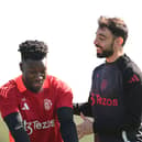 Bruno Fernandes speaks with Andre Onana of Manchester United during a training session ahead of their UEFA Europa League 2024/25 quarter final first leg match at Carrington Training Ground on April 09, 2025 in Manchester, England. (Photo by Ben Roberts Photo/Getty Images)