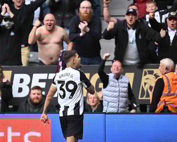 Newcastle United's Brazilian midfielder #39 Bruno Guimaraes celebrates in front of fans after scoring their fourth goal during the English Premier League football match between Newcastle United and Manchester United at St James' Park in Newcastle-upon-Tyne, north east England on April 13, 2025. (Photo by ANDY BUCHANAN / AFP)