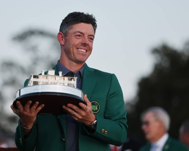 Rory McIlroy poses with the Masters trophy in his green jacket after victory at Augusta