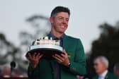 Rory McIlroy poses with the Masters trophy in his green jacket after victory at Augusta