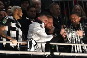 Newcastle United head coach Eddie Howe celebrates with the trophy with coaches Graeme Jones (l) and Jason Tindall (r) after during the Carabao Cup Final between Liverpool and Newcastle United at Wembley Stadium on March 16, 2025 in London, England. (Photo by Stu Forster/Getty Images)
