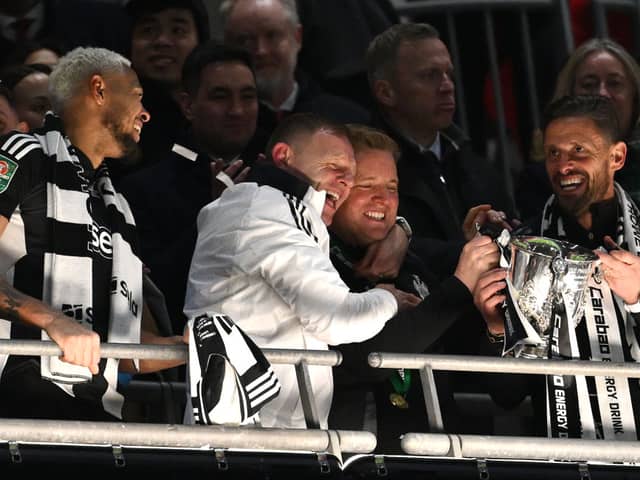 Newcastle United head coach Eddie Howe celebrates with the trophy with coaches Graeme Jones (l) and Jason Tindall (r) after during the Carabao Cup Final between Liverpool and Newcastle United at Wembley Stadium on March 16, 2025 in London, England. (Photo by Stu Forster/Getty Images)