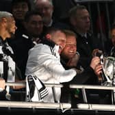 Newcastle United head coach Eddie Howe celebrates with the trophy with coaches Graeme Jones (l) and Jason Tindall (r) after during the Carabao Cup Final between Liverpool and Newcastle United at Wembley Stadium on March 16, 2025 in London, England. (Photo by Stu Forster/Getty Images)