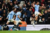 Manchester City's Portuguese midfielder #27 Matheus Nunes (R) celebrates after scoring his team second goal during the English Premier League football match between Manchester City and Aston Villa at the Etihad Stadium in Manchester, north west England, on April 22, 2025. (Photo by Oli SCARFF / AFP) /      