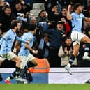 Manchester City's Portuguese midfielder #27 Matheus Nunes (R) celebrates after scoring his team second goal during the English Premier League football match between Manchester City and Aston Villa at the Etihad Stadium in Manchester, north west England, on April 22, 2025. (Photo by Oli SCARFF / AFP) /      