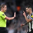 Referee John Brooks gestures as he is confronted by Bruno Guimaraes of Newcastle United during the Carabao Cup Final between Liverpool and Newcastle United at Wembley Stadium on March 16, 2025 in London, England. (Photo by Justin Setterfield/Getty Images)