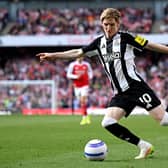 Anthony Gordon of Newcastle United crosses the ball during the Premier League match between Arsenal FC and Newcastle United FC at Emirates Stadium on May 18, 2025 in London, England.