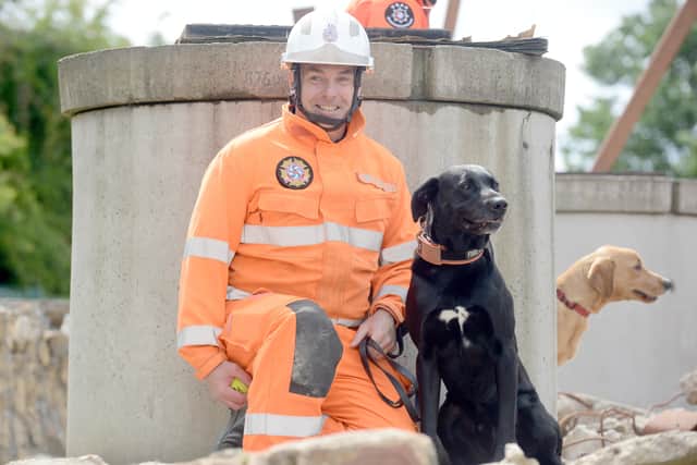 Watch manager Steve Carr with Merlin the search and rescue dog.