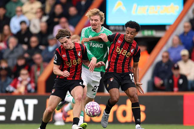 Nick Woltemade of Newcastle United is challenged by Alex Scott and Tyler Adams of AFC Bournemouth during the Premier League match between Bournemouth and Newcastle United at Vitality Stadium on September 21, 2025 in Bournemouth, England.