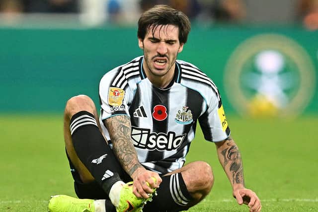 Newcastle United's Italian midfielder #08 Sandro Tonali holds his foot after being fouled during the English League Cup fourth round football match between Newcastle United and Tottenham Hotspur at St James' Park in Newcastle-upon-Tyne, north east England on October 29, 2025. (Photo by ANDY BUCHANAN / AFP) 