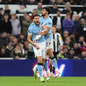 Ruben Dias of Manchester City (L) celebrates scoring his team's first goal with teammate Matheus Nunes (R) during the Premier League match between Newcastle United and Manchester City at St James' Park on November 22, 2025 in Newcastle upon Tyne, England. (Photo by Stu Forster/Getty Images)