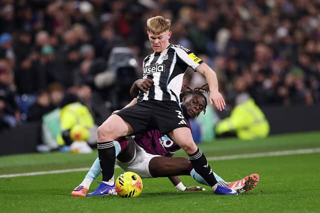 Lewis Hall of Newcastle United is tackled by Lesley Ugochukwu of Burnley during the Premier League match between Burnley and Newcastle United at Turf Moor on December 30, 2025 in Burnley, England. (Photo by Stu Forster/Getty Images)