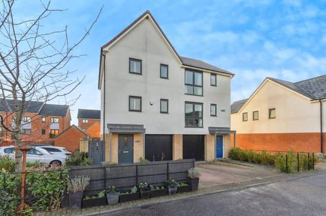 A modern town house with driveway and integral garage set within a popular residential development