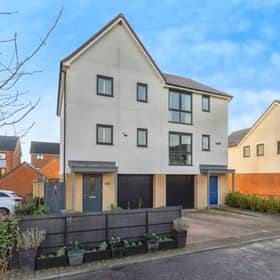 A modern town house with driveway and integral garage set within a popular residential development