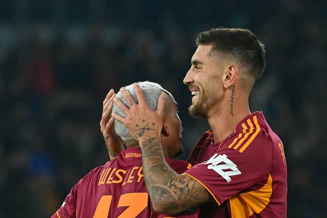 Roma's Brazilian defender #43 Wesley (L) celebrates with Roma's Italian midfielder #07 Lorenzo Pellegrini after scoring a goal during the Italian Serie A football match between AS Roma and Como at the Olympic Stadium in Rome on December 15, 2025. (Photo by Filippo MONTEFORTE / AFP via Getty Images)