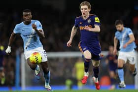 Manchester City's English defender #15 Marc Guehi (L) vies with Newcastle United's English midfielder #10 Anthony Gordon (R) during the English Premier League football match between Manchester City and Newcastle at the Etihad Stadium in Manchester, north west England, on February 21, 2026. (Photo by Darren Staples / AFP via Getty Images)