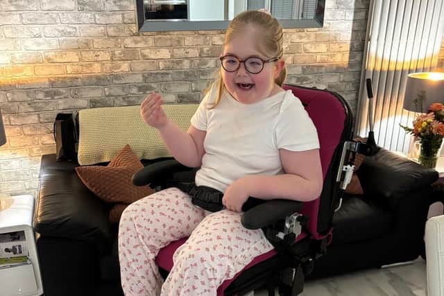 Seren-Grace Brady smiles for the photo at her home. She is one of only 250 children in the world with a rare syndrome.