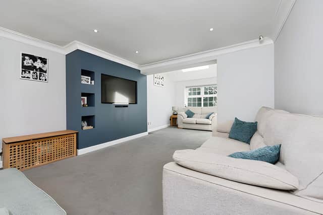 The generous living room provides a comfortable setting for relaxing or entertaining throughout the year