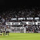 The Newcastle United team line up as fans display a welcome message to new manager, Eddie Howe in 2021.
But Eddie could not be there after testing positive for Covid-19  before the game against Brentford. (Photo by George Wood/Getty Images)