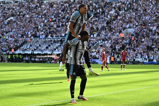 Newcastle United's English midfielder #19 Anthony Elanga celebrates with Newcastle United's Danish striker #10 William Osula after scoring the opening goal during the English Premier League football match between Newcastle United and Liverpool at St James' Park in Newcastle-upon-Tyne, north east England on August 23, 2026. (Photo by Paul ELLIS / AFP via Getty Images)