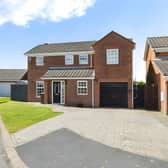 The Alcroft Close home has a lawned front garden and block-paved driveway with space for at least two cars