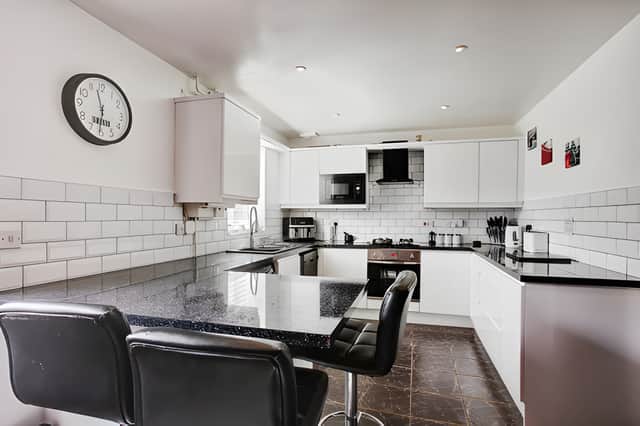 The large modern kitchen provides a practical setting for everyday meals and weekend hosting