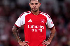 Arsenal midfielder Bruno Guimaraes stands with his hands on his hips